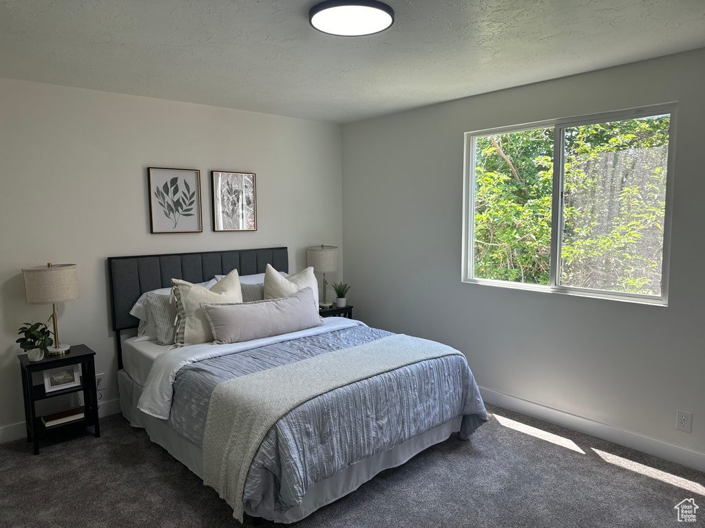 Bedroom featuring carpet flooring and baseboards