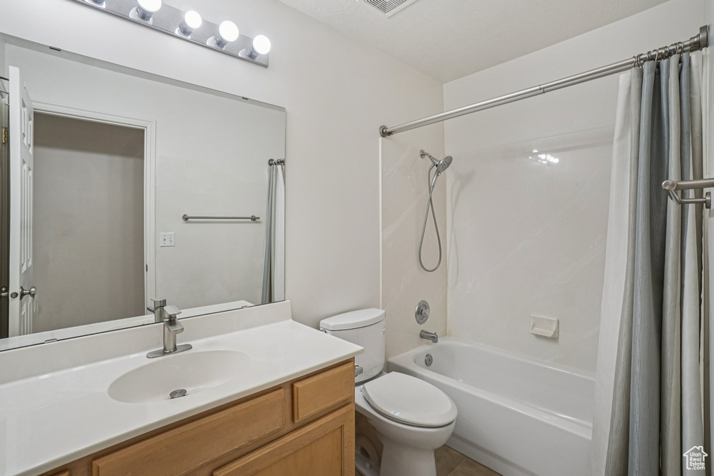 Full bath featuring shower / bath combo with shower curtain and vanity