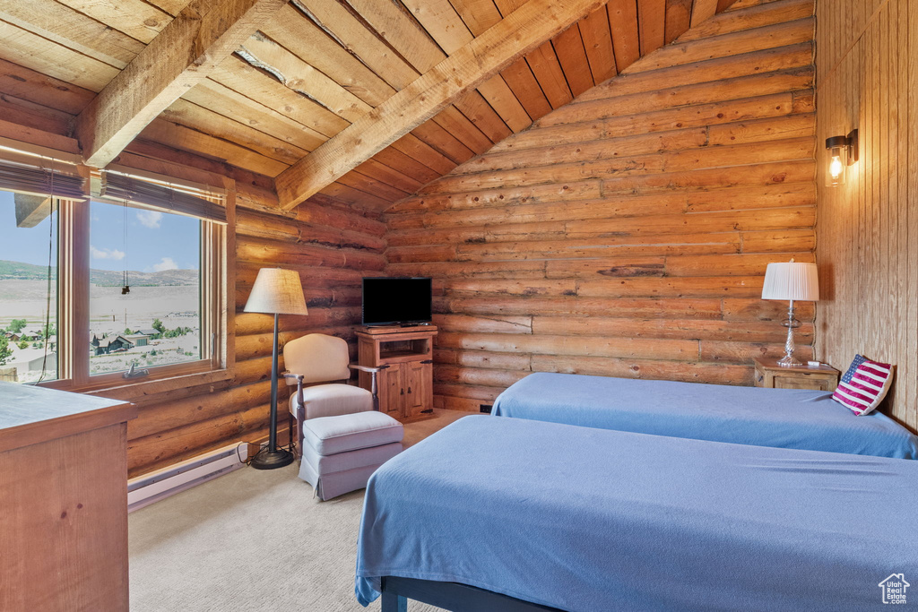 Carpeted bedroom with wooden ceiling, a baseboard radiator, and log walls