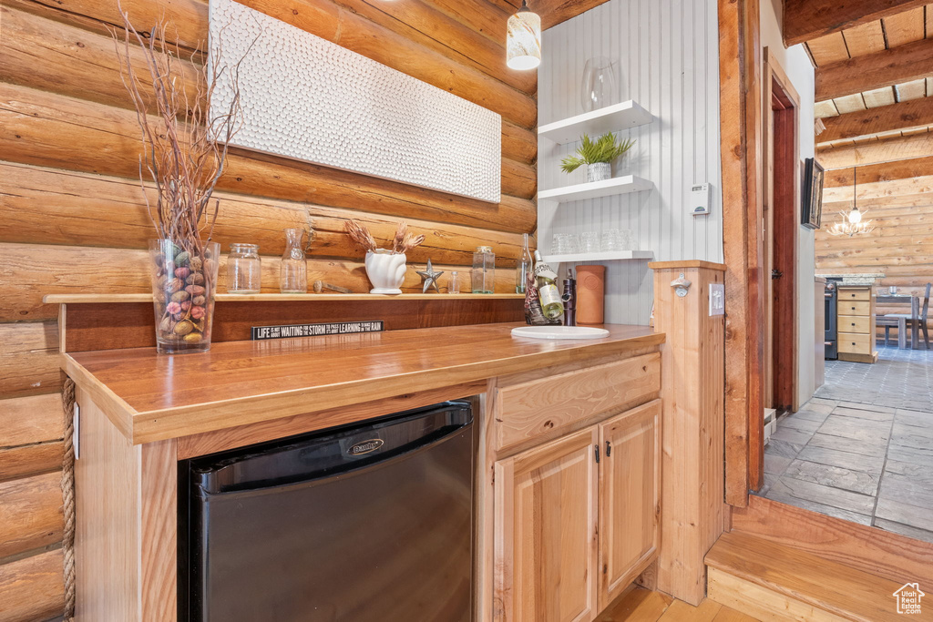 Indoor dry bar featuring log walls and dishwashing machine