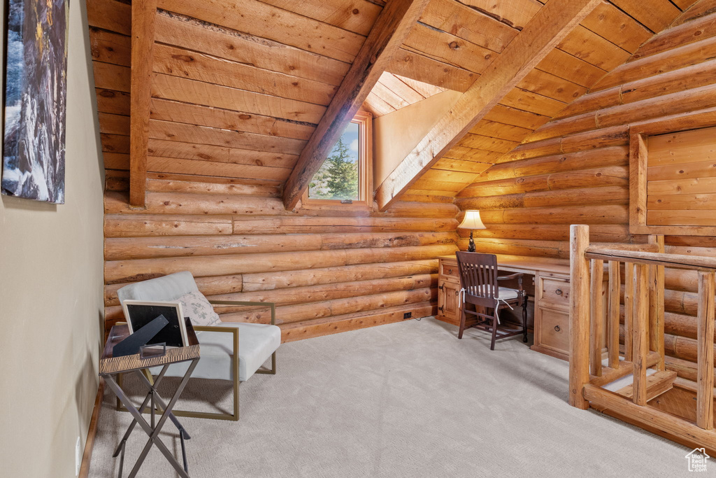Carpeted home office with wood ceiling and rustic walls