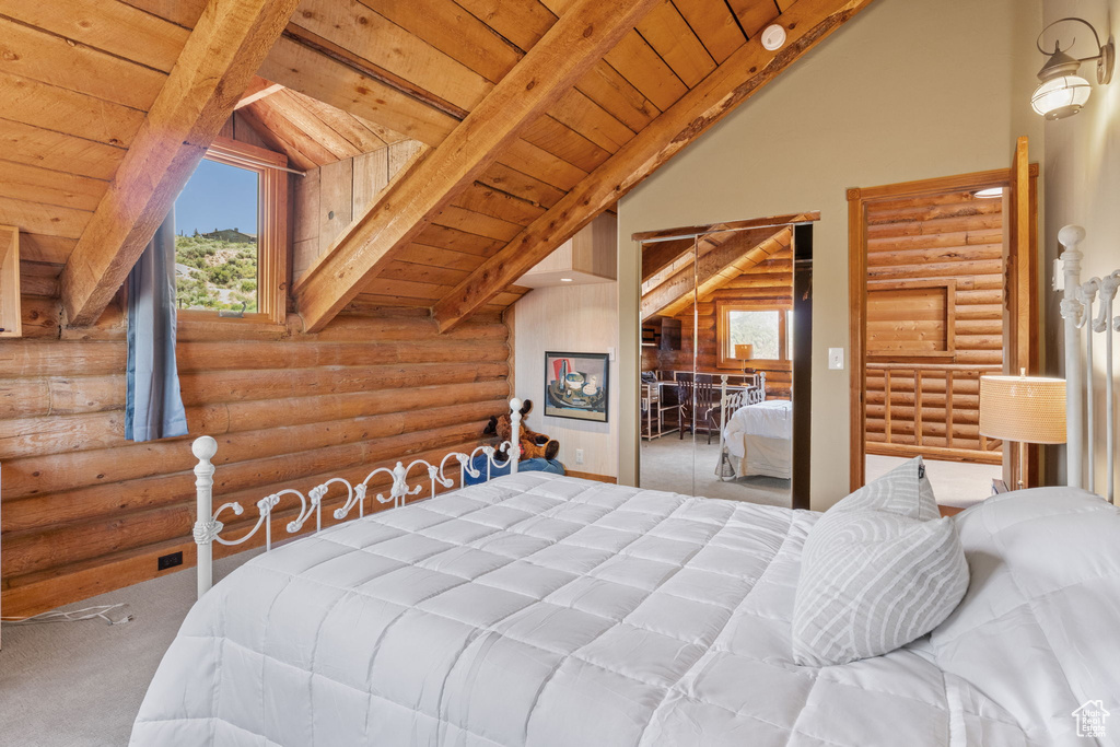 Bedroom featuring rustic walls, carpet floors, a wood ceiling with exposed beams, and high vaulted ceiling