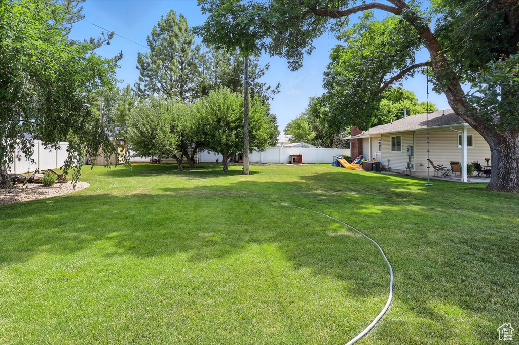 Fenced backyard with a patio area