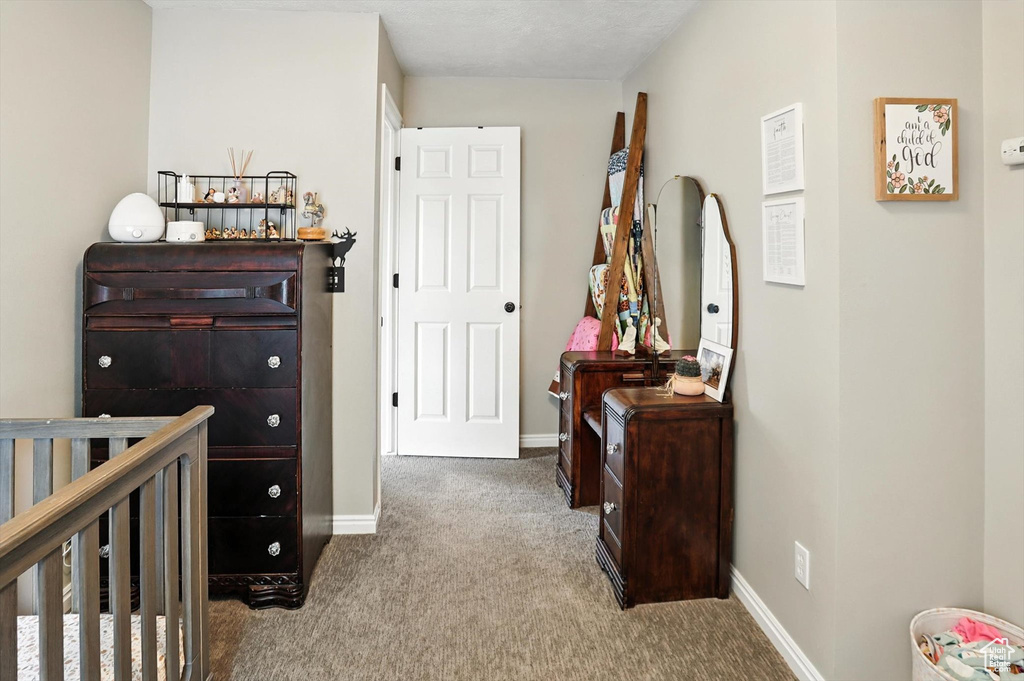 Carpeted bedroom featuring baseboards
