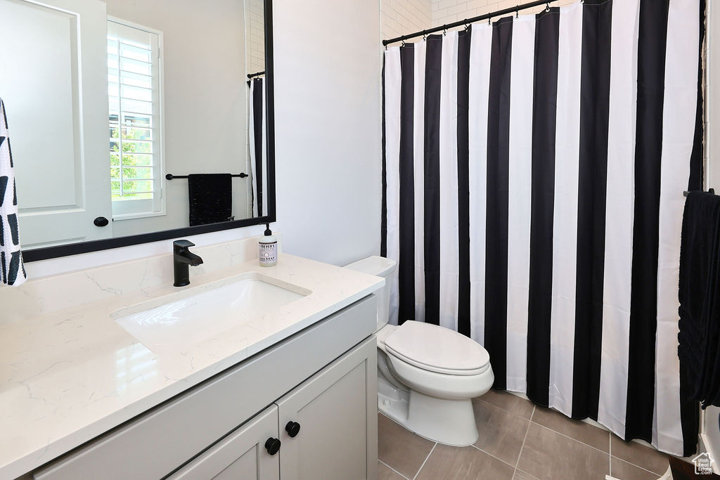 Bathroom featuring vanity, tile patterned floors, and a shower with shower curtain