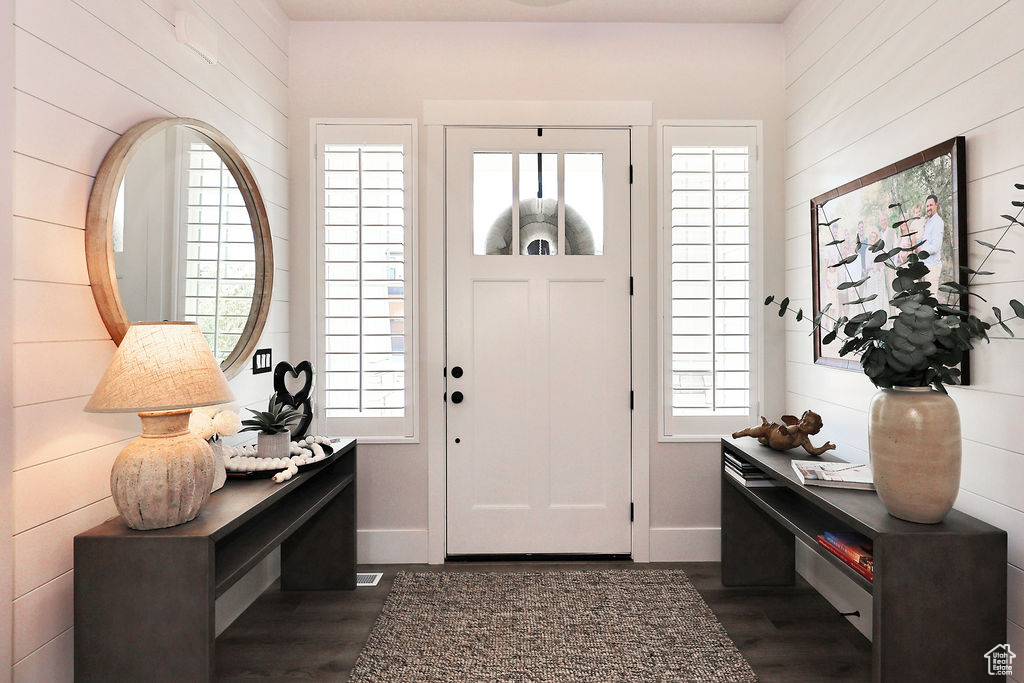Entryway featuring dark wood-type flooring and baseboards