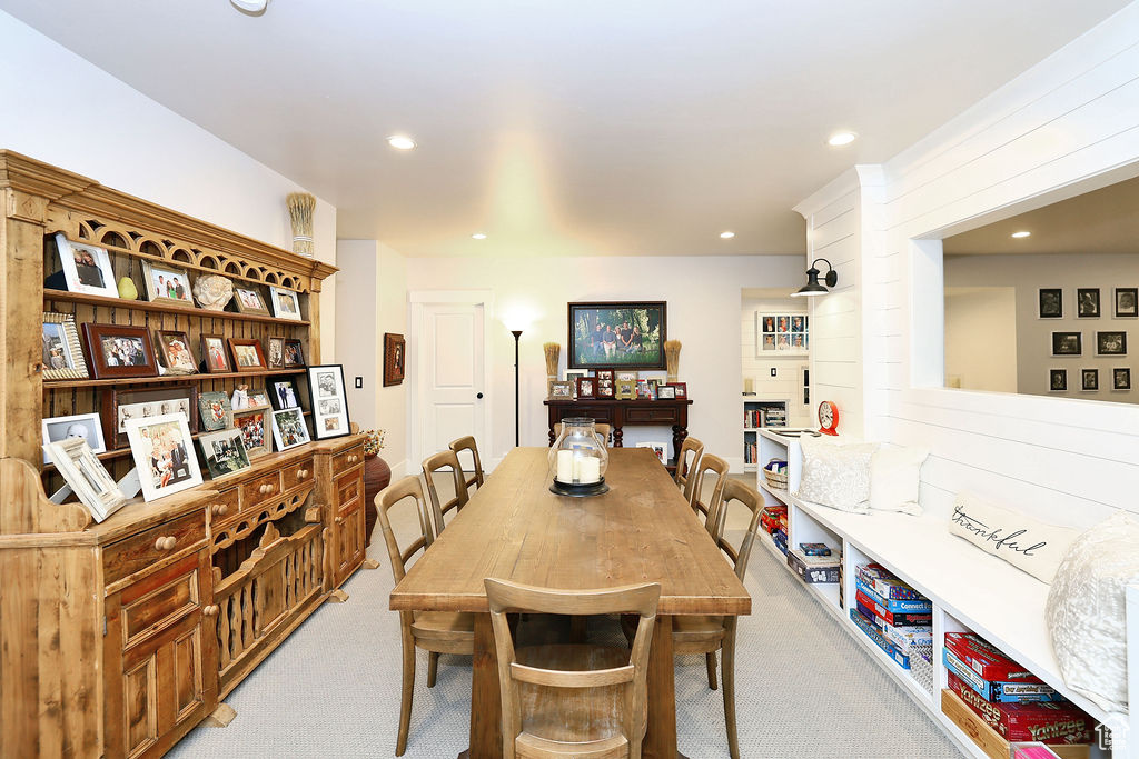 Dining space with light carpet and recessed lighting
