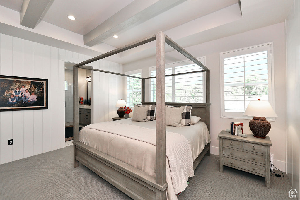 Bedroom featuring carpet, beamed ceiling, ensuite bath, and recessed lighting