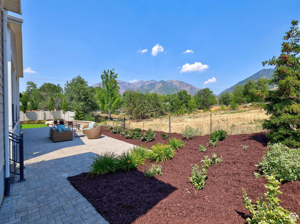 View of yard with an outdoor hangout area, a mountain view, and a patio