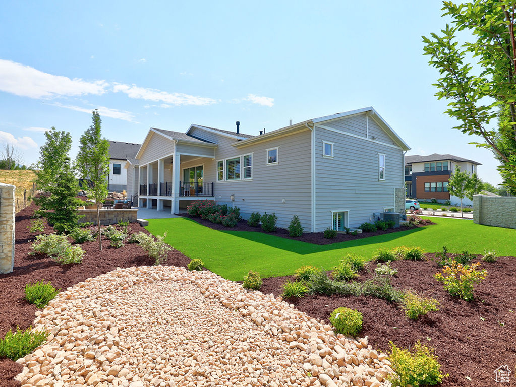 Back of property with a lawn
