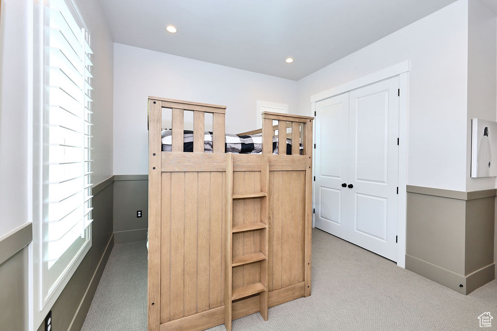 Bedroom with carpet flooring, recessed lighting, and a closet
