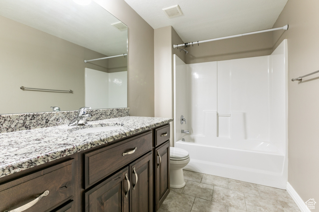 Bathroom featuring vanity, washtub / shower combination, and tile patterned floors