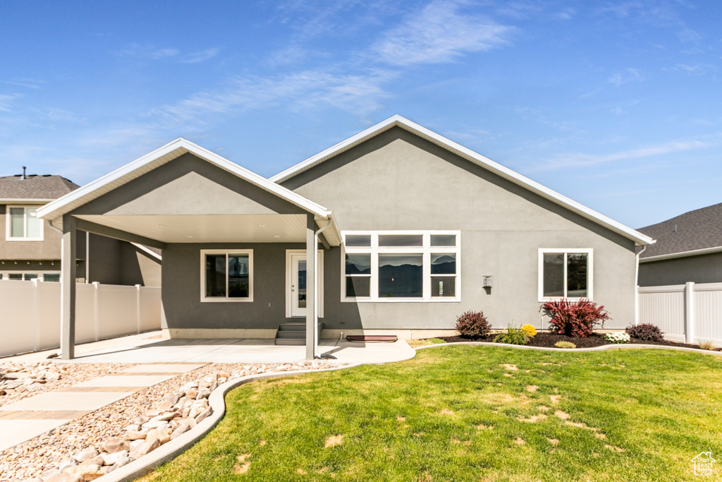 Rear view of property with stucco siding, a patio area, and entry steps