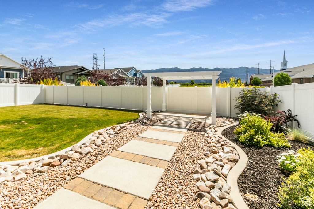 Fenced backyard with a mountain view and a patio