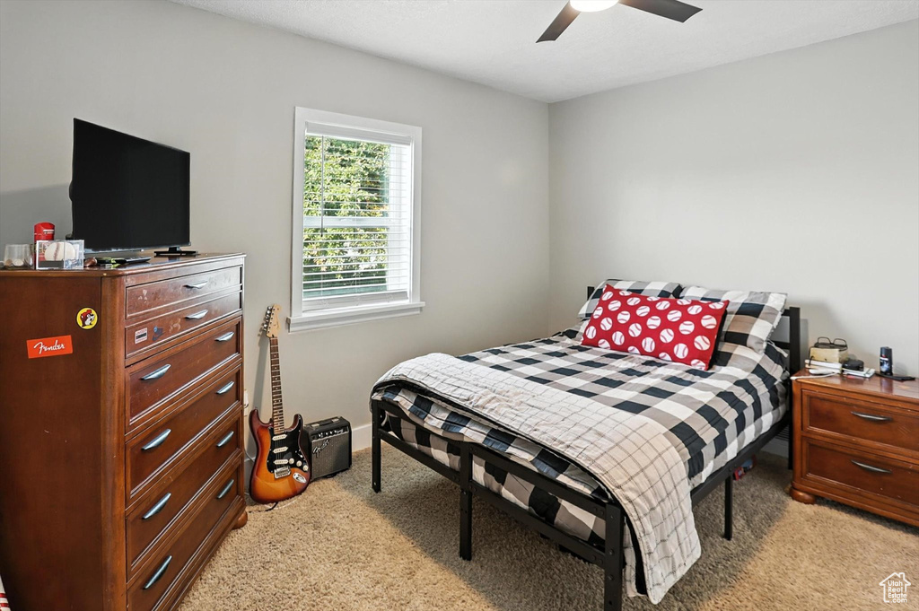 Bedroom with light colored carpet and ceiling fan