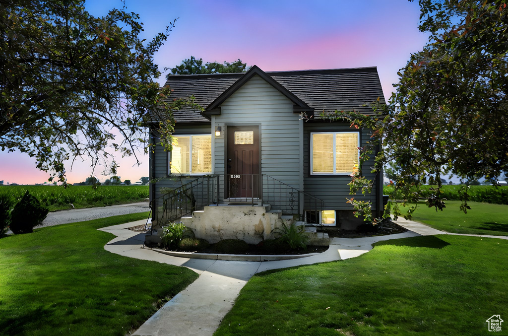 Bungalow-style home with a yard