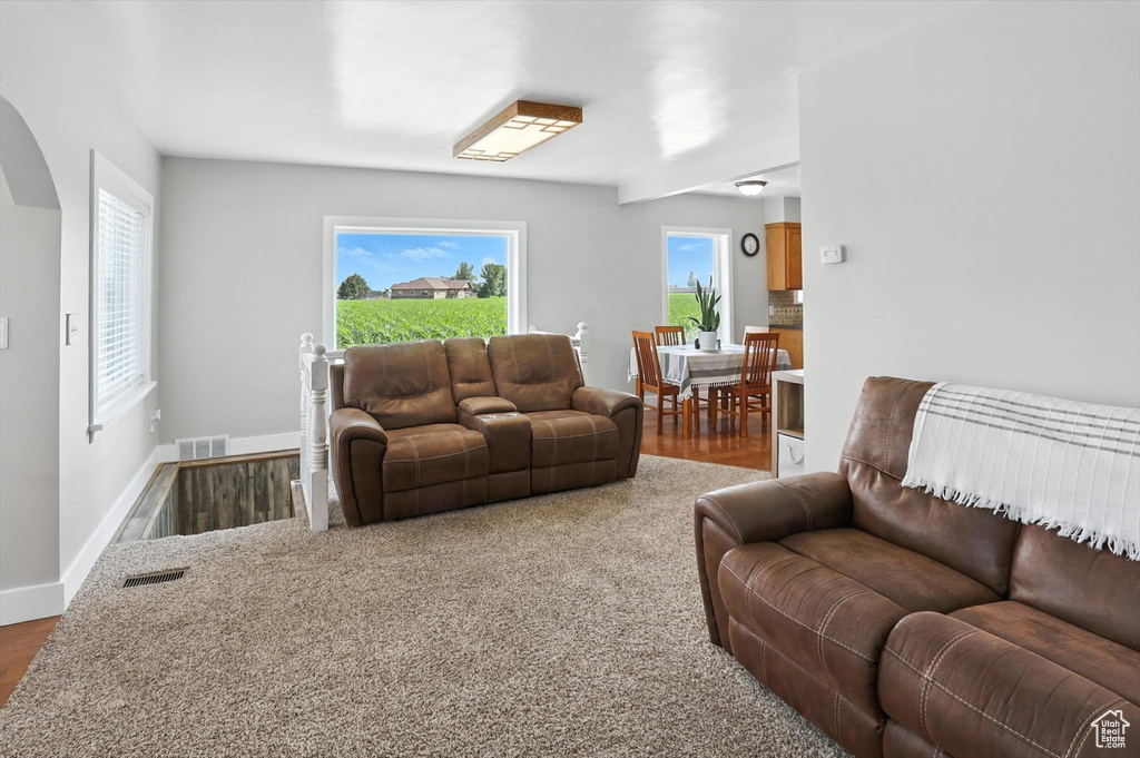Living area with wood finished floors and baseboards