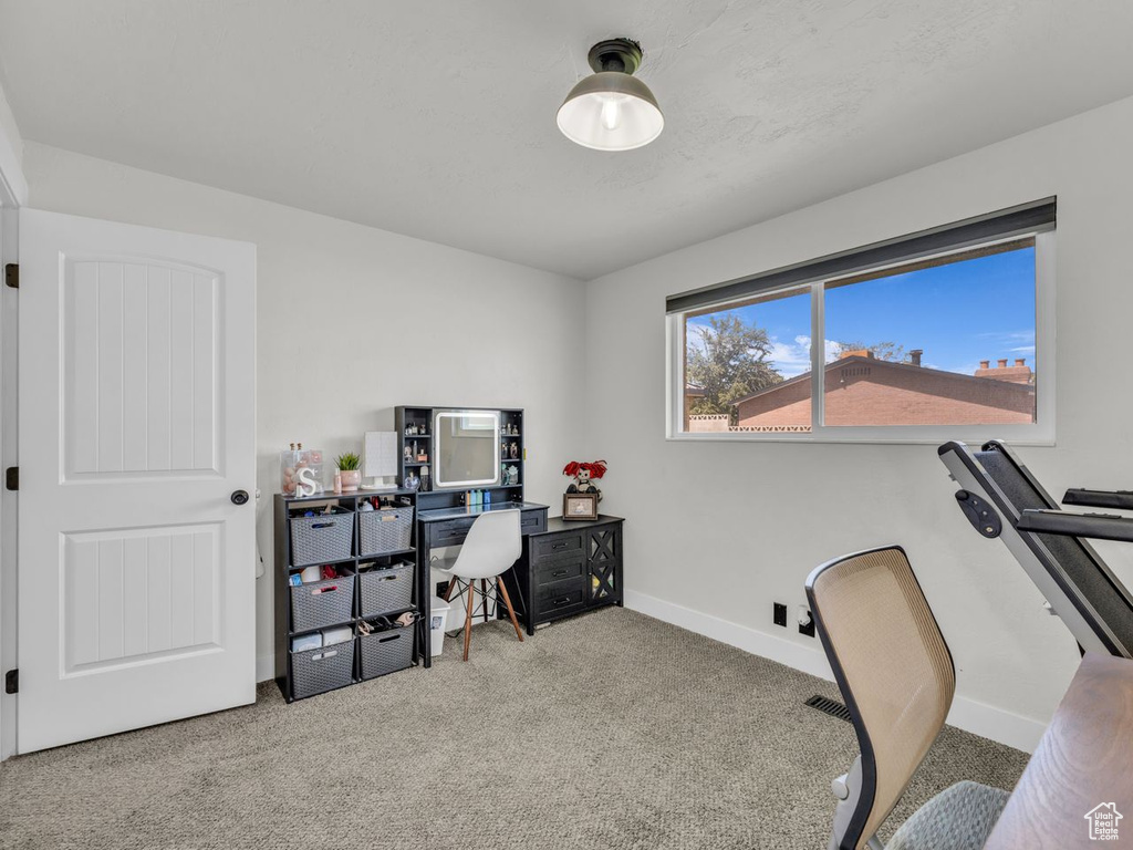 Carpeted office space featuring baseboards