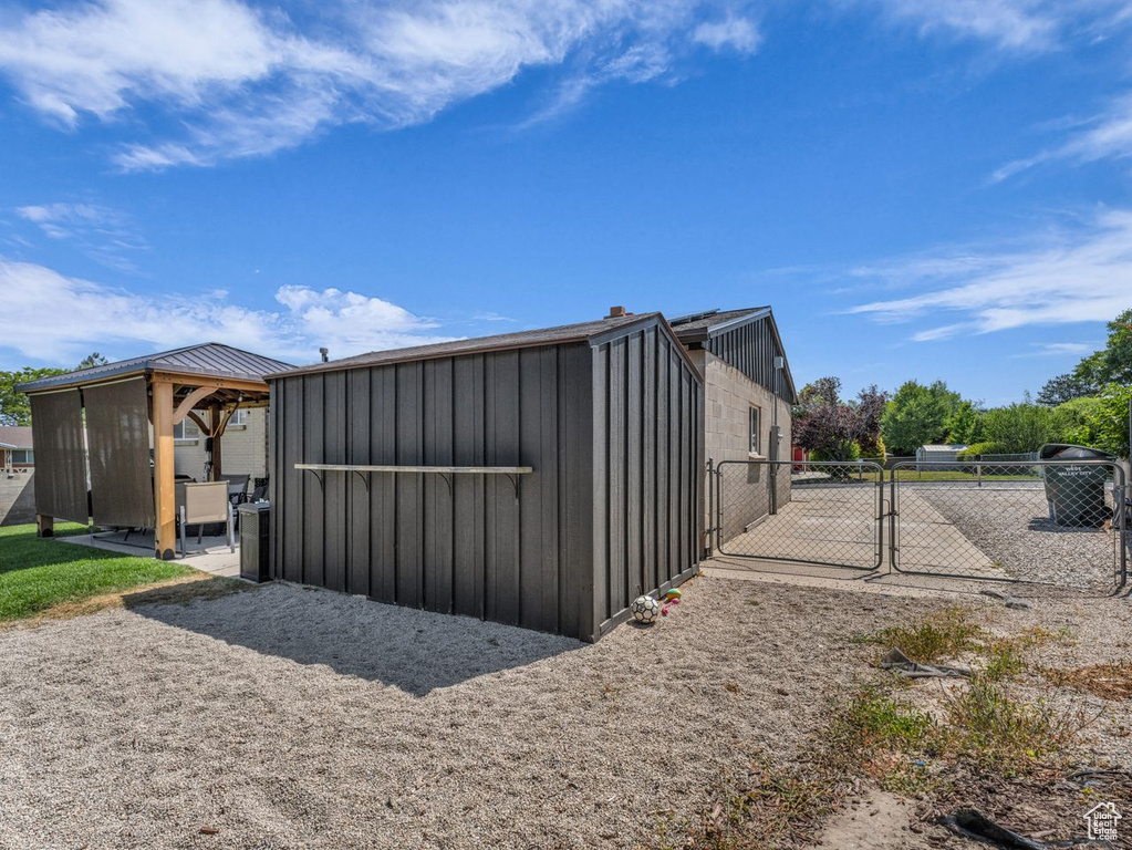 View of outbuilding featuring a gate