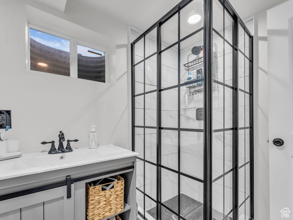 Full bathroom featuring a stall shower and vanity