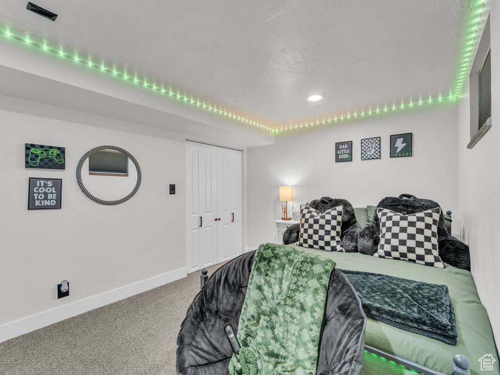 Carpeted bedroom with a closet and recessed lighting