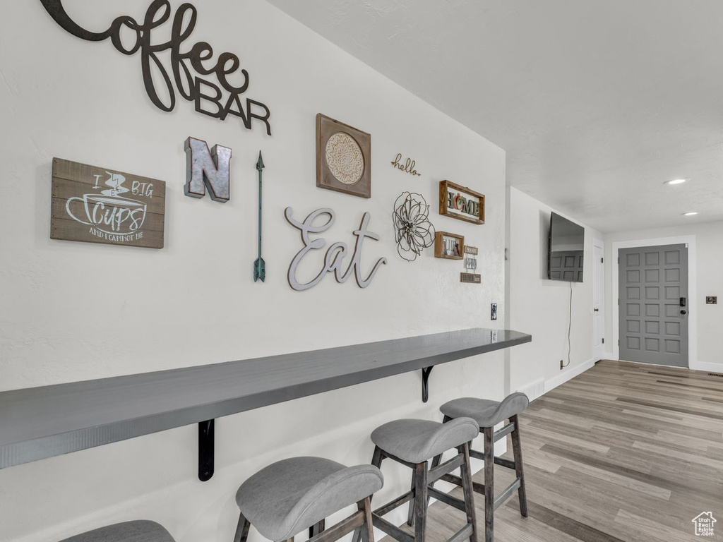 Dining area featuring wood finished floors and recessed lighting