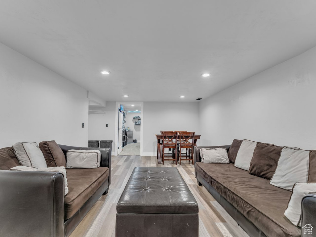 Living area with recessed lighting and light wood finished floors