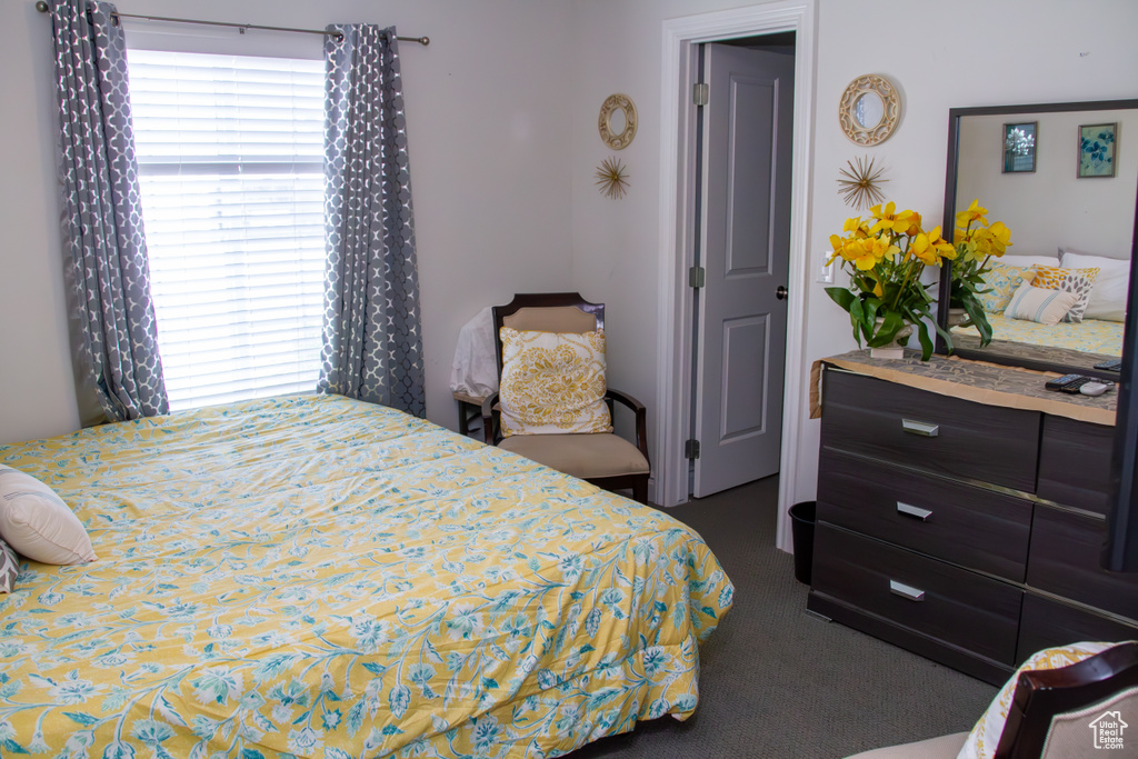 Bedroom featuring dark colored carpet