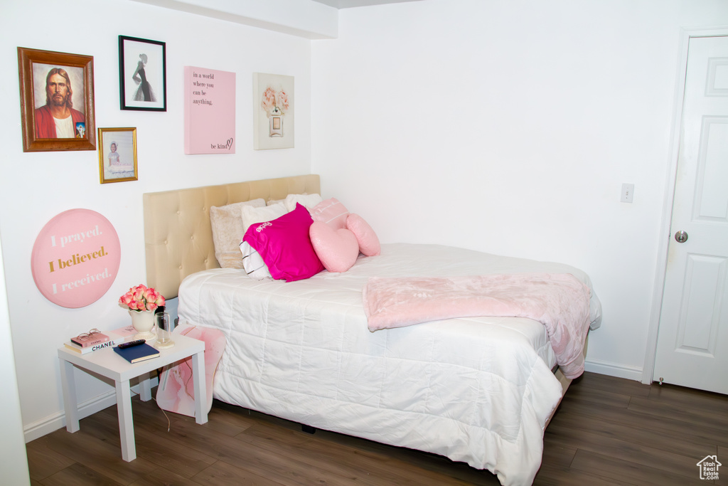 Bedroom featuring wood finished floors and baseboards