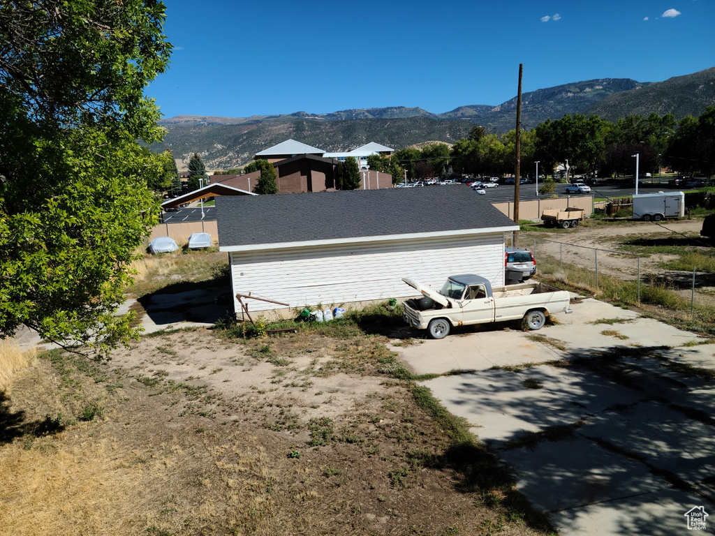 View of side of home with a mountain view