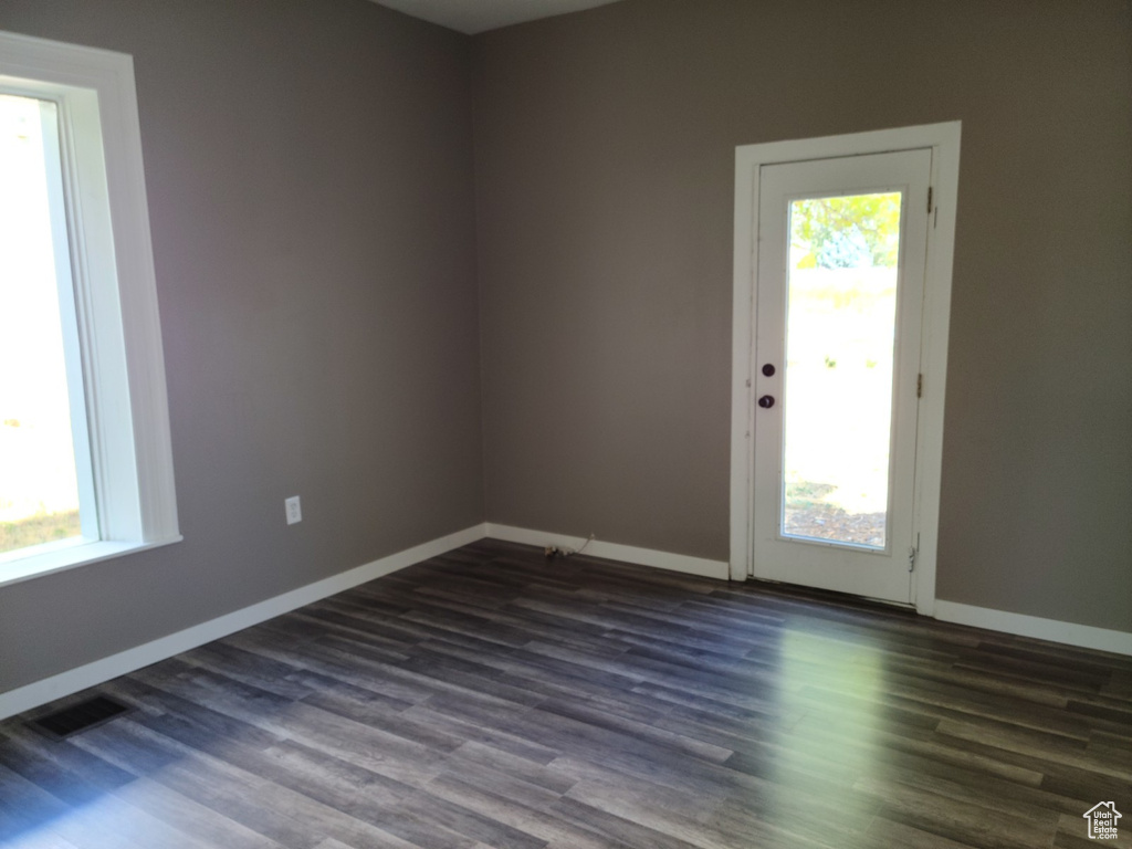 Empty room featuring dark wood finished floors