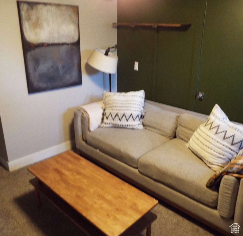 Living area with carpet and baseboards