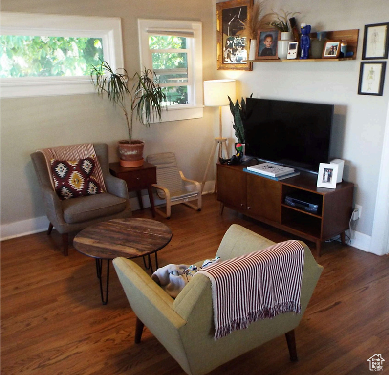 Living room with wood finished floors and baseboards