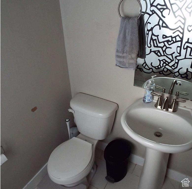 Bathroom featuring baseboards and tile patterned floors