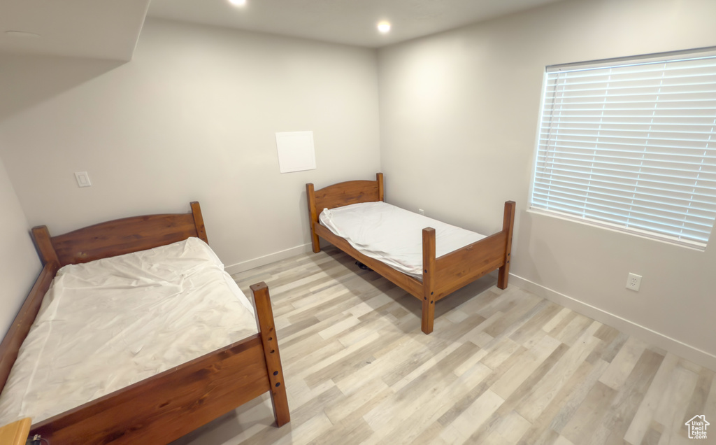 Bedroom with light wood finished floors and recessed lighting
