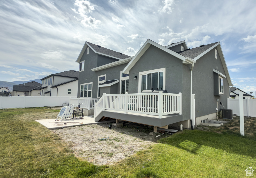 Back of property with a patio, a fenced backyard, a deck, stucco siding, and roof with shingles
