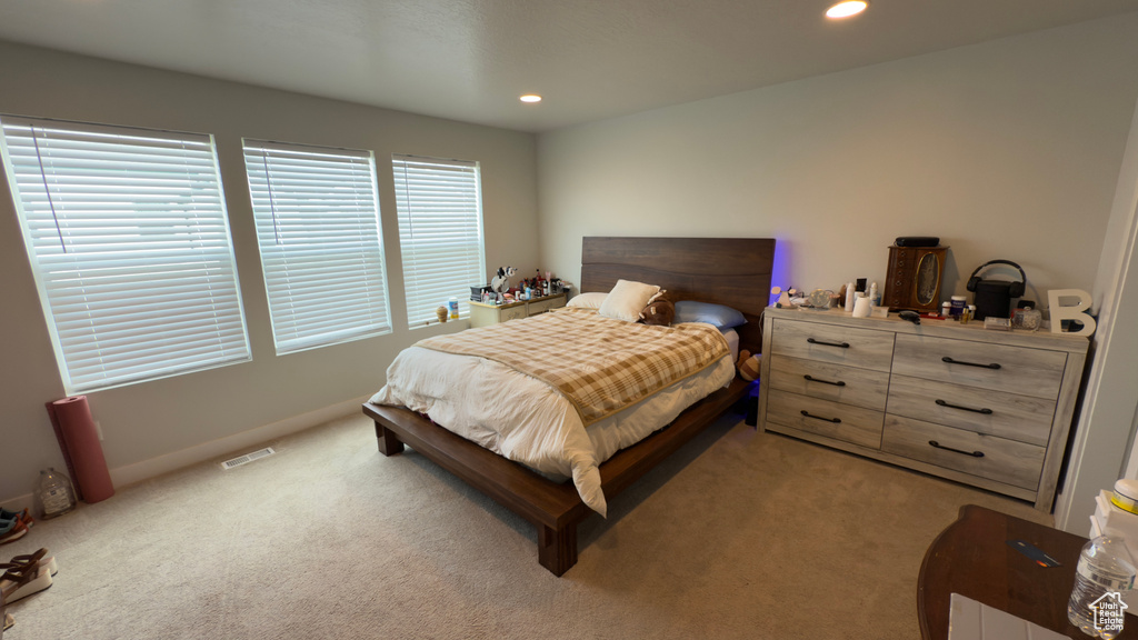 Bedroom with light carpet and recessed lighting