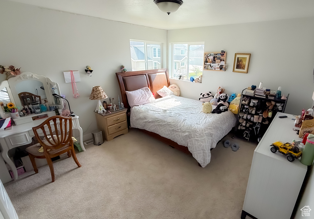 Bedroom with light colored carpet
