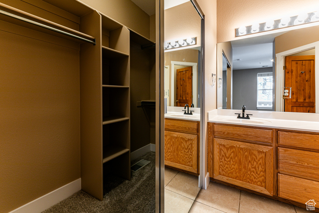 Full bath with vanity and tile patterned flooring