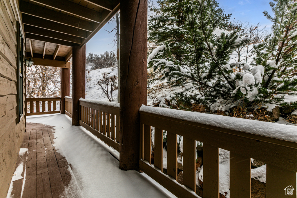 View of snow covered back of property