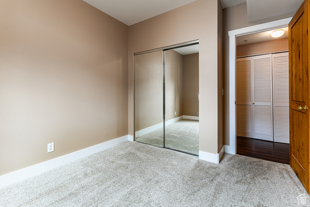 Unfurnished bedroom featuring carpet floors and baseboards