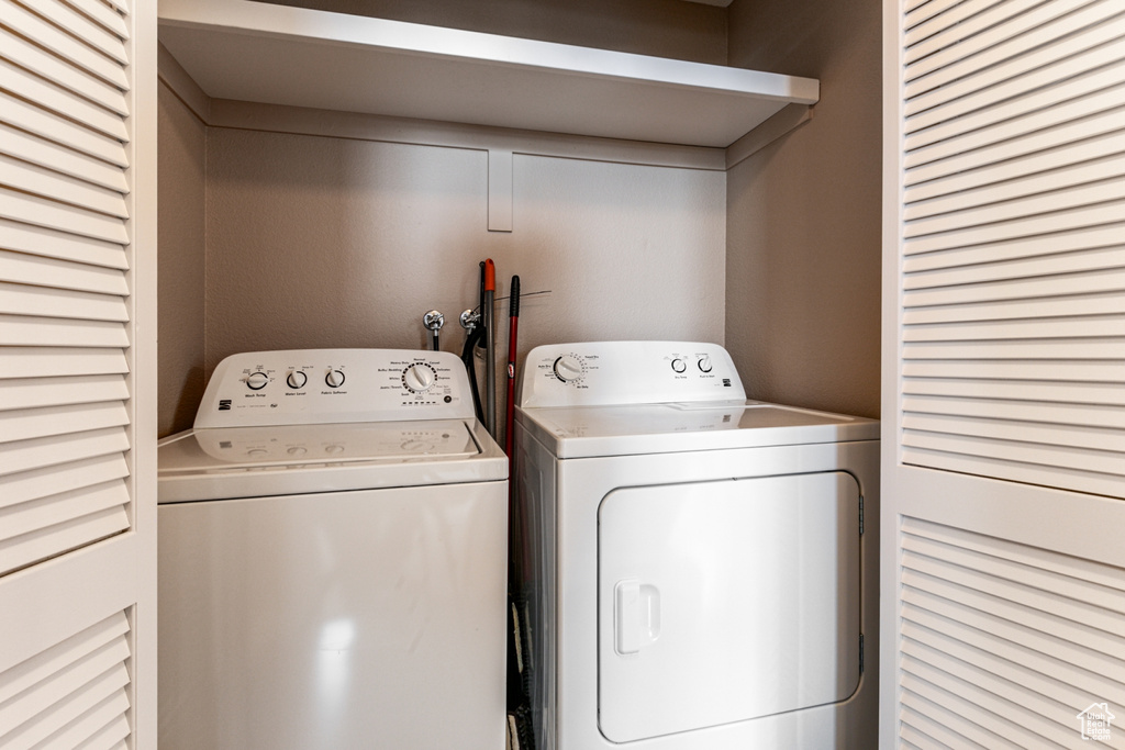 Laundry room with washer and clothes dryer