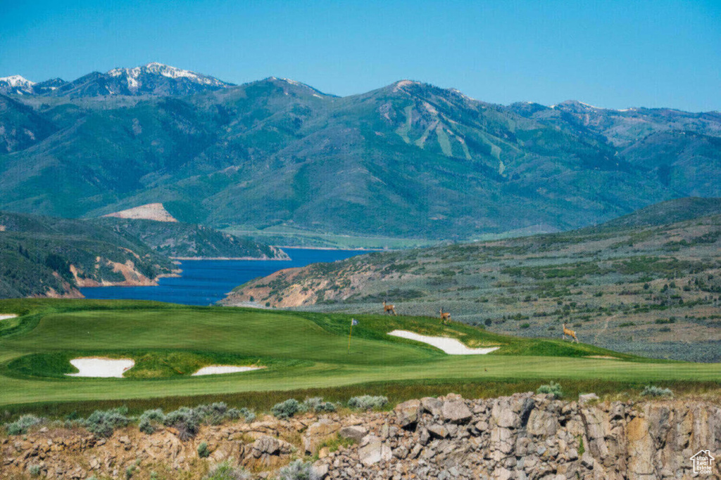 View of mountain background with a golf club and a nearby body of water