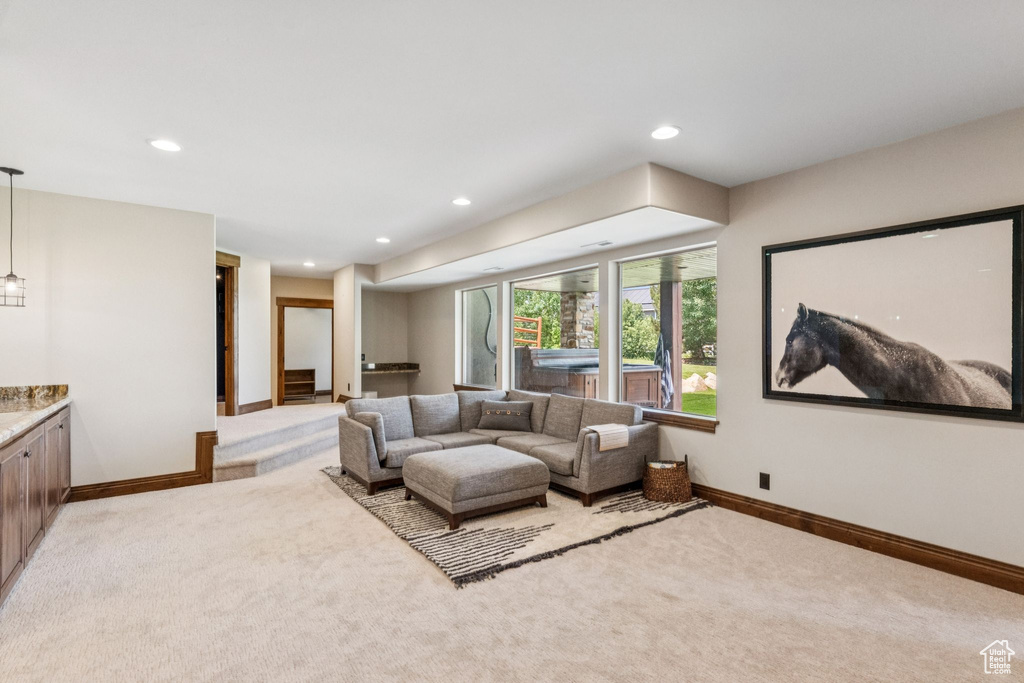 Living area featuring light colored carpet and recessed lighting