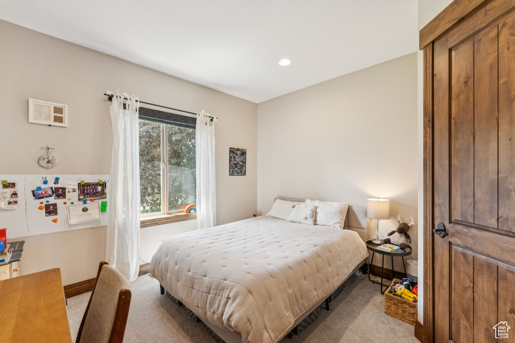 Carpeted bedroom with baseboards and recessed lighting