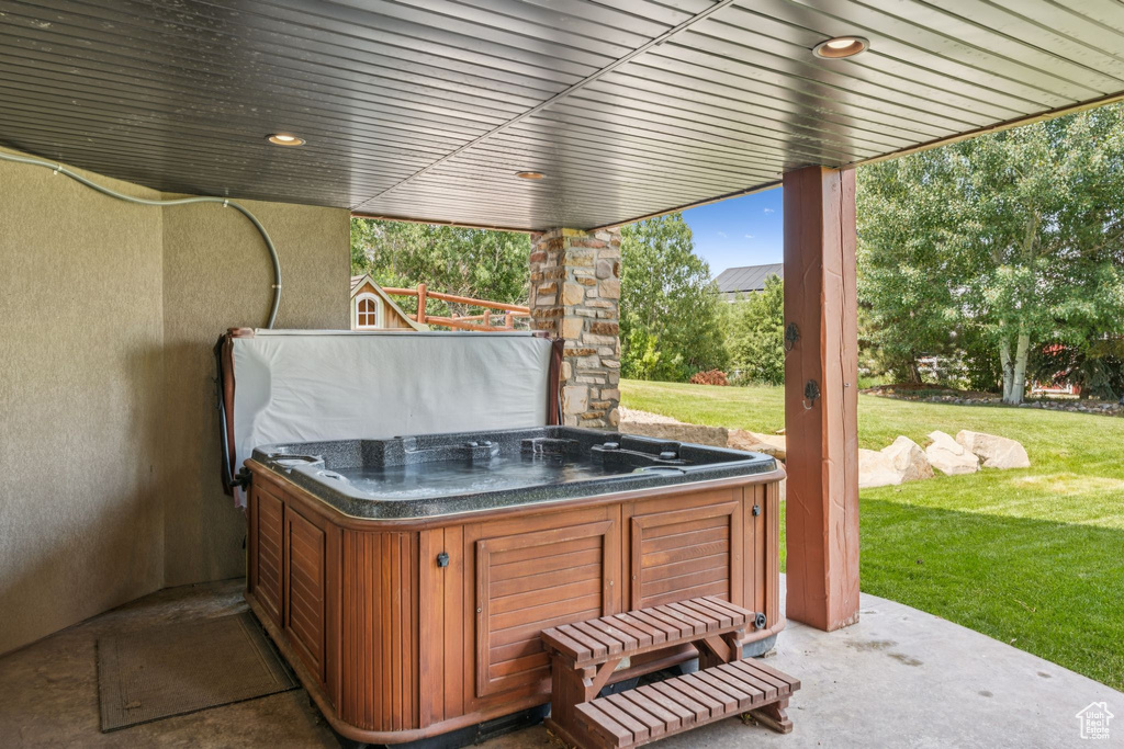 View of patio with a hot tub