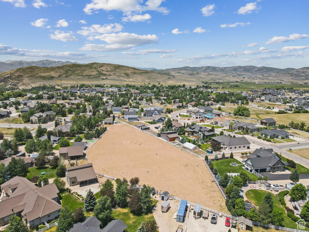 Aerial overview of property's location with nearby suburban area and a mountainous background