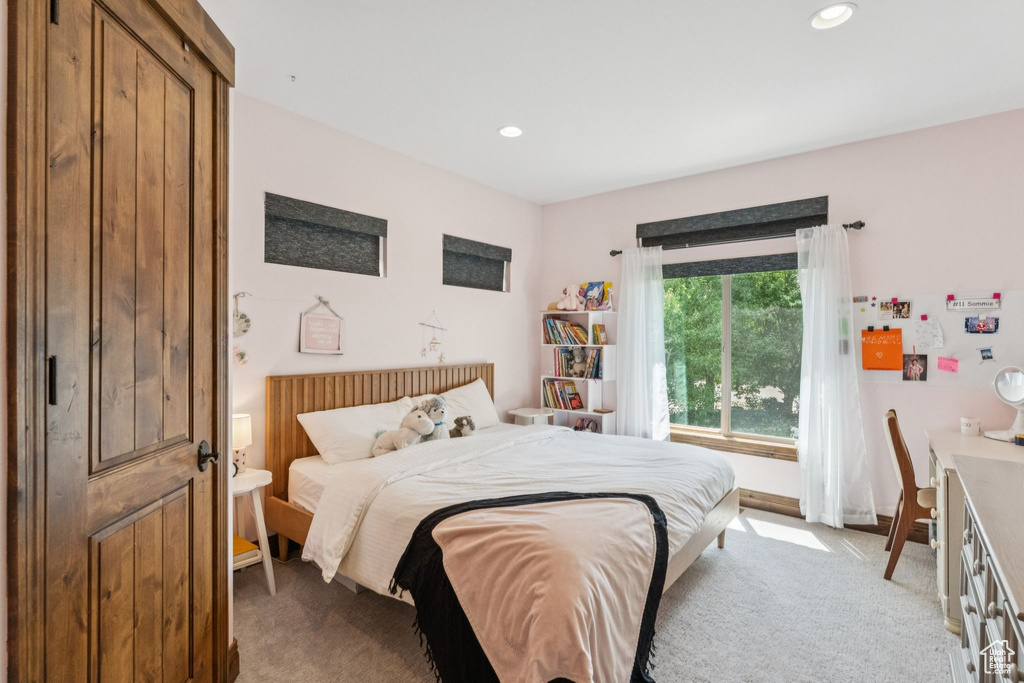 Bedroom with light carpet and recessed lighting