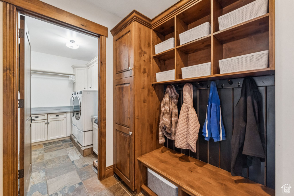 Mudroom featuring washer and dryer and stone finish floors