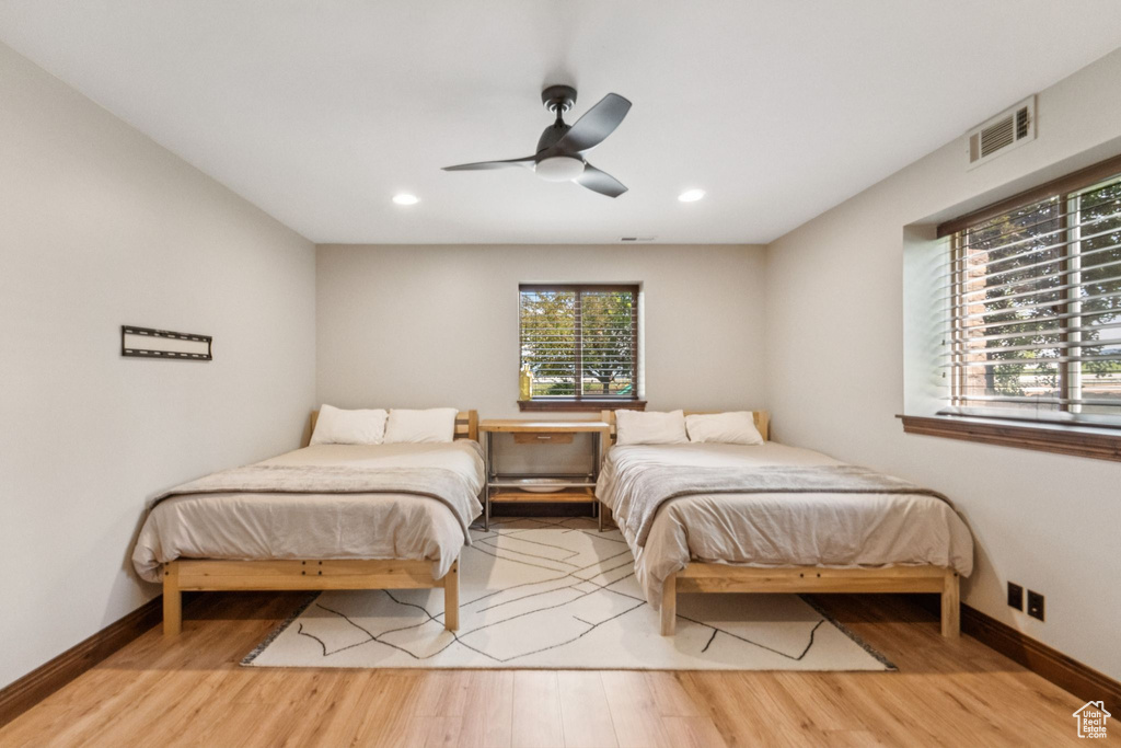 Bedroom featuring wood finished floors, recessed lighting, and ceiling fan